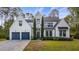 Stunning home with a manicured lawn, a three-car garage, and elegant architectural details at 9134 Mossy Oak Ln, Clermont, FL 34711