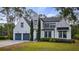 Stunning home with a manicured lawn, a three-car garage, and elegant architectural details at 9134 Mossy Oak Ln, Clermont, FL 34711