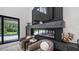 Elegant fireplace in the living room with stylish seating and views of the pool at 9134 Mossy Oak Ln, Clermont, FL 34711