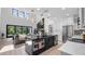 Open-concept kitchen with stainless steel appliances, black island, and views to the living room at 9134 Mossy Oak Ln, Clermont, FL 34711