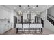 Modern kitchen with white cabinets, stainless steel appliances and a large center island with bar seating at 9134 Mossy Oak Ln, Clermont, FL 34711