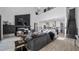 Bright, open living room boasts a soaring ceiling, fireplace, and seamless flow to the kitchen and staircase at 9134 Mossy Oak Ln, Clermont, FL 34711