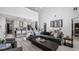 Bright, open-concept living room featuring soaring ceilings, hardwood floors, and a seamless flow to the kitchen at 9134 Mossy Oak Ln, Clermont, FL 34711