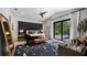 Inviting main bedroom with a private backyard view, a decorative rug, and a padded headboard wall at 9134 Mossy Oak Ln, Clermont, FL 34711