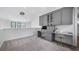 Bright office space with built-in cabinetry, workspace, and unique chandelier lighting at 9134 Mossy Oak Ln, Clermont, FL 34711