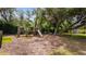 Playground shaded by mature trees with wood benches at 9134 Mossy Oak Ln, Clermont, FL 34711