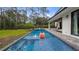 Enjoy the refreshing pool with a fun slide, perfect for outdoor relaxation and recreation at 9134 Mossy Oak Ln, Clermont, FL 34711
