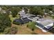 An aerial of the home showing solar panels, screened in lanai and surrounding community at 923 Oleander St, The Villages, FL 32159