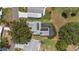 An aerial view showing the home's roof, solar panels, screened in lanai and neighborhood at 923 Oleander St, The Villages, FL 32159