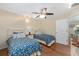 Cozy bedroom showcasing twin beds with floral bedding, complemented by hardwood flooring at 923 Oleander St, The Villages, FL 32159