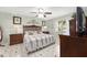 This bedroom has cool green walls, tiled floors, a ceiling fan, two dressers, and a bed with two nightstands at 923 Oleander St, The Villages, FL 32159