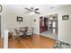 Bright breakfast nook with a ceiling fan, wainscoting, hardwood floors, and views into the entryway and kitchen at 923 Oleander St, The Villages, FL 32159