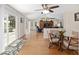 Cozy dining area featuring wood floors, patio access, and an open layout to the living area at 923 Oleander St, The Villages, FL 32159