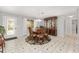 Dining room featuring tile floors, a decorative rug, and a decorative glass entry door at 923 Oleander St, The Villages, FL 32159