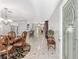 Bright foyer with decorative front door, beautiful tile floors, and views into the dining room and kitchen at 923 Oleander St, The Villages, FL 32159