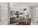Modern kitchen with granite counters, stainless appliances, white cabinets, and an island with seating at 923 Oleander St, The Villages, FL 32159
