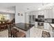 Stylish kitchen with white cabinetry, stainless steel appliances, a breakfast bar, and views into the dining area at 923 Oleander St, The Villages, FL 32159