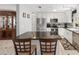 Modern kitchen with granite counters, stainless appliances, white cabinets, and an island with seating at 923 Oleander St, The Villages, FL 32159