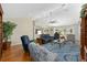 Bright and spacious living room area with a ceiling fan and beautiful wood flooring at 923 Oleander St, The Villages, FL 32159