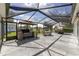 Spacious screened patio with outdoor kitchen and dining area, perfect for entertaining at 923 Oleander St, The Villages, FL 32159
