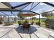 Relaxing screened patio showcasing a dining table and open view of the backyard at 923 Oleander St, The Villages, FL 32159