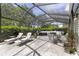 Large screened patio features comfortable seating, outdoor kitchen and spa, perfect for outdoor enjoyment at 923 Oleander St, The Villages, FL 32159