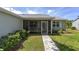 Inviting screened front porch with stone pavers and two comfortable rocking chairs, perfect for relaxing at 923 Oleander St, The Villages, FL 32159