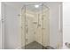 Bright bathroom featuring a modern, glass-enclosed shower with a rainfall showerhead and built-in niche at 923 Oleander St, The Villages, FL 32159