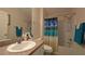 Bright bathroom with a shower-tub combo and beach-themed shower curtain at 971 Margaux Trl, The Villages, FL 32162