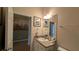 Cozy bathroom featuring framed palm tree art and a vanity with good lighting at 971 Margaux Trl, The Villages, FL 32162