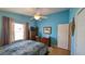 Inviting bedroom with natural light, wood floors, and a ceiling fan at 971 Margaux Trl, The Villages, FL 32162