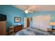 Bedroom with a ceiling fan, wood floors, and a door to a closet at 971 Margaux Trl, The Villages, FL 32162