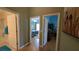 Hallway with views into the bathroom, bedroom, and bonus room at 971 Margaux Trl, The Villages, FL 32162