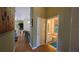 Hallway view of an open kitchen and a bathroom with a blue rug at 971 Margaux Trl, The Villages, FL 32162