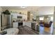 Well-equipped kitchen offering stainless steel appliances, white cabinets, and access to a spacious living area at 971 Margaux Trl, The Villages, FL 32162