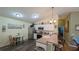 Well-lit kitchen with modern stainless steel appliances and an adjacent bar area for additional seating at 971 Margaux Trl, The Villages, FL 32162