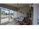 Enclosed lanai furnished with comfortable seating offers a tranquil space for relaxation at 971 Margaux Trl, The Villages, FL 32162