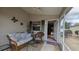 Enclosed lanai furnished with comfortable seating offers a tranquil space for relaxation at 971 Margaux Trl, The Villages, FL 32162