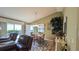 Comfortable living area featuring a dining space, hardwood floors, and great natural light at 971 Margaux Trl, The Villages, FL 32162
