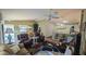 Spacious living room offering plenty of seating, a ceiling fan, and an open layout to the kitchen at 971 Margaux Trl, The Villages, FL 32162