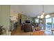 Bright living room featuring hardwood floors, comfortable seating, and sliding glass doors to outdoor area at 971 Margaux Trl, The Villages, FL 32162