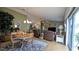 Open concept living area with hardwood floors, a dining area, and abundant natural light at 971 Margaux Trl, The Villages, FL 32162