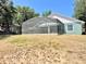 Spacious backyard featuring a screened lanai, offering a private outdoor living space at 974 Forest Hill Dr, Minneola, FL 34715