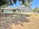 Expansive backyard featuring a screened lanai, creating a perfect outdoor oasis for relaxation at 974 Forest Hill Dr, Minneola, FL 34715