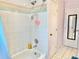 Bathroom featuring classic tile, a bathtub with shower, and a mirror to the bedroom at 974 Forest Hill Dr, Minneola, FL 34715
