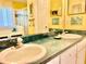 Bathroom featuring dual sinks, a soaking tub, and a glass-enclosed shower at 974 Forest Hill Dr, Minneola, FL 34715