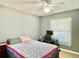 Bedroom featuring a desk, chair and computer, large window, and comfortable bed at 974 Forest Hill Dr, Minneola, FL 34715