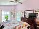 Bedroom boasting a large dresser and slider doors offering a view of the screened pool area at 974 Forest Hill Dr, Minneola, FL 34715