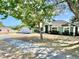 View of the home's exterior and landscaped front yard, enhanced by a mature tree that provides ample shade at 974 Forest Hill Dr, Minneola, FL 34715