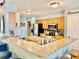 Spacious kitchen featuring a breakfast bar, stainless steel appliances, and wood cabinets at 974 Forest Hill Dr, Minneola, FL 34715